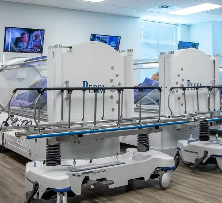 Row of treatment beds with a TV for each one